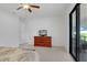 Bedroom with ceiling fan, tiled floor, dresser and a large window that leads to the outdoor space at 1214 Florablu Dr, Seffner, FL 33584