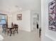 Bright dining room featuring a modern chandelier, large windows, and decorative butterfly art at 1214 Florablu Dr, Seffner, FL 33584