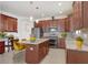 Well-equipped kitchen features granite countertops, stainless steel appliances, and center island with breakfast bar seating at 1214 Florablu Dr, Seffner, FL 33584