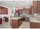 Spacious kitchen with a large island, stainless steel appliances, and dark wood cabinetry at 1214 Florablu Dr, Seffner, FL 33584