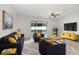 Spacious living room filled with natural light boasts hardwood floors, stylish furniture, and a large television at 1214 Florablu Dr, Seffner, FL 33584
