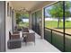 Relaxing screened-in patio with seating provides a tranquil outdoor space overlooking the manicured lawn at 1214 Florablu Dr, Seffner, FL 33584