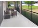 Spacious screened patio with stylish seating and view of the backyard at 1214 Florablu Dr, Seffner, FL 33584