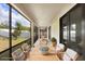Screened patio featuring a dining table and ample seating overlooking the backyard at 1214 Florablu Dr, Seffner, FL 33584