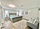 Bright bedroom features modern decor, a comfortable seating area, and ample natural light at 12432 81St Ct, Seminole, FL 33772