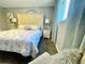 Charming bedroom with a tufted headboard, stylish nightstands and plush chair near a bright window at 12432 81St Ct, Seminole, FL 33772