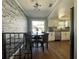 Modern dining area with a faux brick wall, stainless steel appliances, and hardwood floors at 12432 81St Ct, Seminole, FL 33772