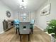Stylish dining room featuring modern decor, ample seating and wood flooring at 12432 81St Ct, Seminole, FL 33772