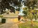 Two-story home featuring a well-maintained yard, a brick-lined driveway, and a welcoming front entrance at 12432 81St Ct, Seminole, FL 33772