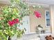 Charming front porch adorned with flowers and a decorative bench, welcoming guests to the home at 12432 81St Ct, Seminole, FL 33772