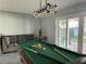 Game room with pool table, comfortable seating, and access to the backyard at 12432 81St Ct, Seminole, FL 33772