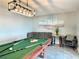Entertainment room features a billiards table, comfortable seating and modern lighting at 12432 81St Ct, Seminole, FL 33772