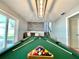 Game room features a pool table, neutral colors, and access to the outdoors at 12432 81St Ct, Seminole, FL 33772