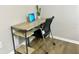 Cozy home office featuring a modern desk with shelves, a laptop, and a comfortable ergonomic chair at 12432 81St Ct, Seminole, FL 33772