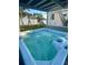 Backyard hot tub with a covered patio and a ' play set, perfect for Gathering fun and relaxation at 12432 81St Ct, Seminole, FL 33772