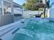 Inviting hot tub in backyard with a hammock and outdoor seating, ideal for relaxation and entertaining at 12432 81St Ct, Seminole, FL 33772