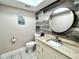 Stylish powder room featuring modern fixtures, granite countertop, and decorative wood wall at 12432 81St Ct, Seminole, FL 33772