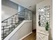 Staircase featuring modern railing and an eye-catching mirror to complement the aesthetic of the home at 12432 81St Ct, Seminole, FL 33772