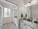 Bright bathroom features a granite countertop, white cabinets, and decorative mirror at 1292 Myers Rd, Brooksville, FL 34602