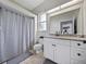 Bathroom featuring tiled floor, granite countertop vanity and shower with striped curtain at 1292 Myers Rd, Brooksville, FL 34602