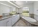 Bright bathroom with a double vanity, soaking tub, and a large window overlooking the yard at 1292 Myers Rd, Brooksville, FL 34602