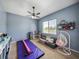Bedroom with gymnastics equipment, comfy couch, and hanging chair near a window at 1292 Myers Rd, Brooksville, FL 34602