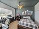 Bedroom with a modern ceiling fan, TV, dark gray walls and carpeted floor at 1292 Myers Rd, Brooksville, FL 34602