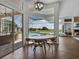 Bright dining area featuring a round table, views of the screened pool, and a modern light fixture at 1292 Myers Rd, Brooksville, FL 34602