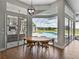 Open dining area with wood floors offering views of the outdoor patio and pool area at 1292 Myers Rd, Brooksville, FL 34602