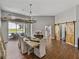 Charming dining room with rustic table, elegant chandelier, and sliding barn doors, perfect for Gathering gatherings at 1292 Myers Rd, Brooksville, FL 34602