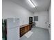The well-lit garage features an extra refrigerator and storage, and painted floor at 1292 Myers Rd, Brooksville, FL 34602
