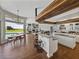 Open concept kitchen with wood beam, granite counters, stainless appliances, island seating and pool views at 1292 Myers Rd, Brooksville, FL 34602