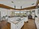 Open-concept kitchen with granite countertops, wood floors, and views of the pool and living room at 1292 Myers Rd, Brooksville, FL 34602