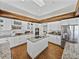 Bright kitchen featuring white cabinets, granite countertops, stainless steel appliances, and wood beam accents at 1292 Myers Rd, Brooksville, FL 34602