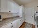Functional laundry room with modern appliances, granite countertop, and ample storage space at 1292 Myers Rd, Brooksville, FL 34602