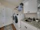 Functional laundry room with modern appliances, granite countertop, and ample storage space at 1292 Myers Rd, Brooksville, FL 34602
