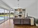 Inviting living room with a fireplace, built-in shelving, wood floors, and views of the screened pool at 1292 Myers Rd, Brooksville, FL 34602
