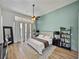 Serene main bedroom featuring modern decor, soft lighting, and tranquil backyard views through large windows at 1292 Myers Rd, Brooksville, FL 34602