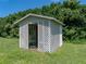 Quaint white lattice outbuilding, surrounded by lush greenery and situated on a lawn at 1292 Myers Rd, Brooksville, FL 34602