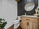 Contemporary powder room showcases a wood vanity with quartz countertop and modern herringbone backsplash at 1292 Myers Rd, Brooksville, FL 34602