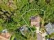 An aerial view showcases the home's private lot surrounded by lush greenery and a screened in pool at 13806 Sumac Pl, Tampa, FL 33625