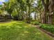 Beautiful backyard with mature trees, lush greenery, and well-maintained landscaping at 13806 Sumac Pl, Tampa, FL 33625