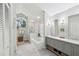 Bright, updated bathroom with dual vanities, a soaking tub, and a walk-in shower at 13806 Sumac Pl, Tampa, FL 33625