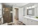 Bathroom featuring tile shower and white vanity with mirror at 13806 Sumac Pl, Tampa, FL 33625
