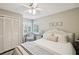 Comfortable bedroom featuring a ceiling fan, windows with shutters, and closet at 13806 Sumac Pl, Tampa, FL 33625