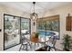 Charming breakfast nook features a round table and view of the pool and backyard at 13806 Sumac Pl, Tampa, FL 33625