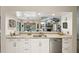 Open kitchen design with stainless steel appliances and view to a living room with fireplace at 13806 Sumac Pl, Tampa, FL 33625