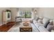 Comfortable living room featuring a neutral color scheme, plush seating, and a large window overlooking the yard at 13806 Sumac Pl, Tampa, FL 33625