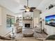Inviting living room features a stone fireplace, built-in shelves, and outdoor view at 13806 Sumac Pl, Tampa, FL 33625