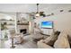 Comfortable living room features a stone fireplace, tv, and comfortable seating at 13806 Sumac Pl, Tampa, FL 33625